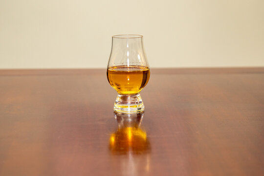 Single malt Scotch whisky with sevada malted and turfed in glencairn glass on rustic wooden table