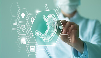 Unrecognizable female doctor holding graphic virtual visualization model of Stomach organ in hands....