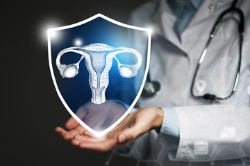 Unrecognizable female doctor holding shield and graphic virtual visualization of Uterus organ in...