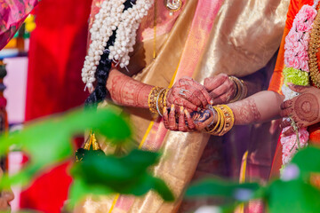 Fototapeta na wymiar Indian Hindu wedding ceremony and rituals bride and groom's hands close up