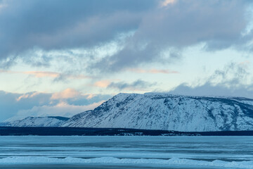 Incredible snow covered mountain landscape in northern Canada during winter with sunset. 