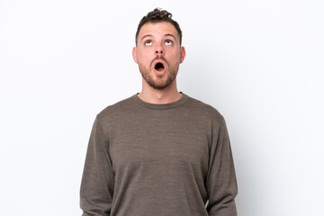 Obraz premium Young Brazilian man isolated on white background looking up and with surprised expression