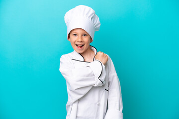 Little chef boy isolated on blue background celebrating a victory