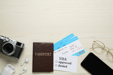 Flat lay composition with passport and tickets on white wooden background, space for text. Visa receiving