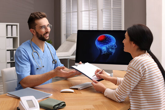 Young Woman Filling Form In Neurologist Office