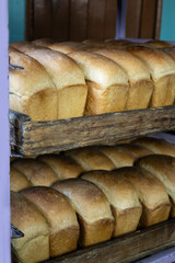 Hot freshly cooked bread is placed in trays in the bakery.