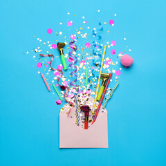 Beautiful flat lay composition with envelope and festive items on light blue background. Surprise...