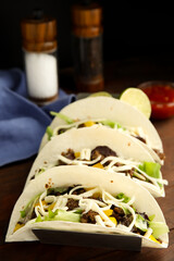 Delicious tacos with fried meat and cheese on table