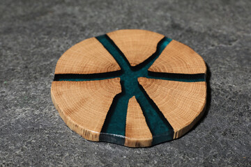 Stylish wooden cup coaster on grey table, closeup