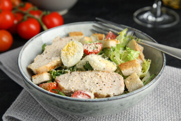 Delicious Caesar salad in bowl, closeup view