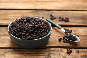 Dried black currant berries on wooden table