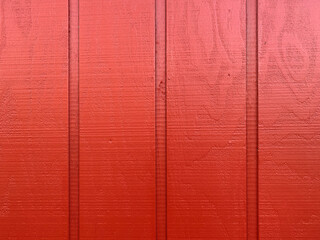 red painted wall fence wood boards siding fresh paint maroon stain cabin house