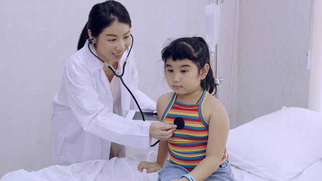 Kid with doctor at hospital. Children health and wellness.