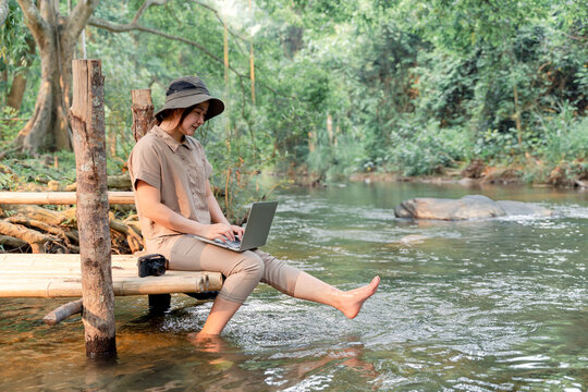 Asian woman travel and camping alone. Businesswoman online working and relaxing during journey outdoor activity.