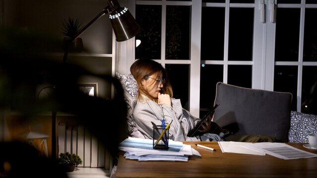 Asian businesswoman online working at the night. Busy and exhausted of work overtime at home