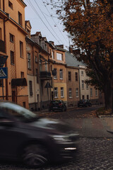 Beautiful tiny street in Lviv. Car movement of foreground