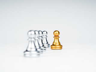 Close-up the golden pawn chess piece moving out from the line of silver pawn chess pieces on white...
