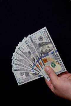 100 dollar bills. Dollar background. black background. Money. hand holding money.