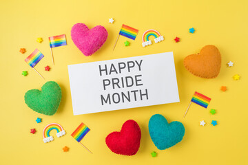 LGBTQ pride month greeting card mock up with rainbow flags and heart shapes. Top view, flat lay