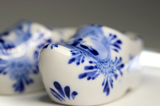 Antique porcelain figurine that imitates traditional Dutch clogs. close up macro photography.