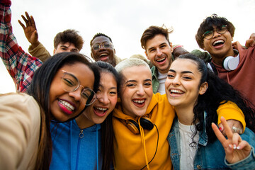 Group of multiracial teen college friends having fun outdoors. Happy people taking selfie. - obrazy, fototapety, plakaty