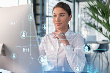 Attractive businesswoman in white shirt at workplace working with laptop to hire new employees for...