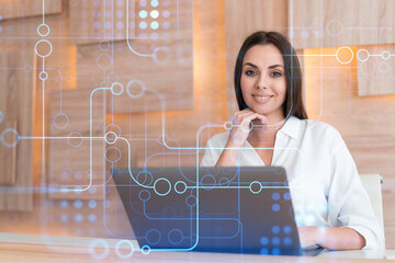 Attractive businesswoman in white shirt at workplace working with laptop to optimize development by...