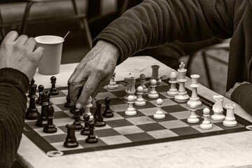 person moving a chessboard piece