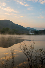 Lake with fog on the water surface in the early morning