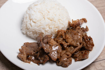 Fried pork with garlic and pepper in a white plate