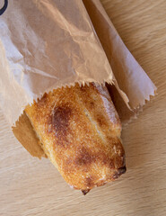 Sourdough bread stick or baguette wrapped for sale in a bakery.
