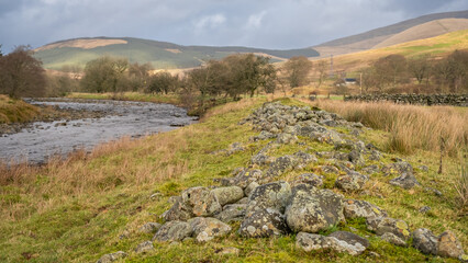 Close up of dredged river rocks offering flood bank protection for fields