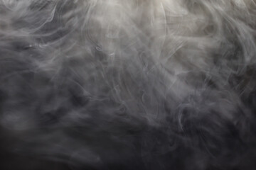 Bizarre swirls of gray smoke creeping in the dark. Clouds of gray smoke.