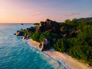 Anse Source d'Argent, La Digue Seychelles, a young couple of men and women on a tropical beach...