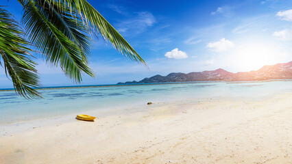 Tropical paradise beach with white sand and coco palms travel tourism with sunrise.