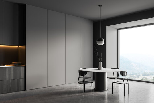 Grey eating room interior with chairs and table, panoramic window