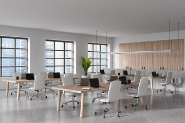 Workplace interior with computer and armchair, panoramic window on city view