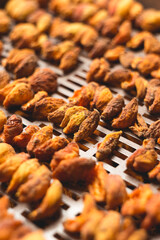 The process of home cooking dried fruits in an electric dryer.