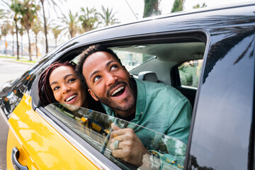 Happy hispanic latino couple taking a taxi
