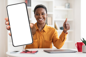 Smiling black woman showing smartphone with empty screen, mockup