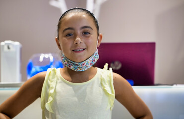 Confident young caucasian girl smiling to the camera in a modern recording studio.