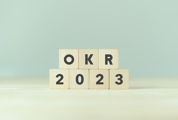 2023 OKR,Objectives, Key and Results. Business target and drive business and performance. Focus on goals. Achievement business growth by flexible management strategies. Wooden cubes with OKR and 2023