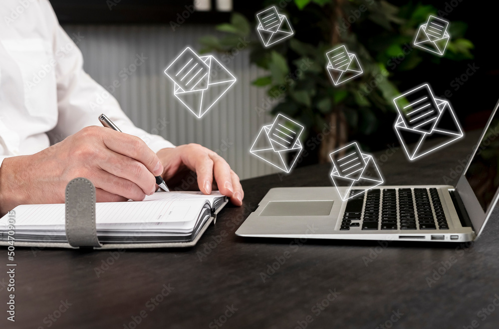 Poster businessman receiving a lot of emails, clients requests. man taking notes in planner while working o