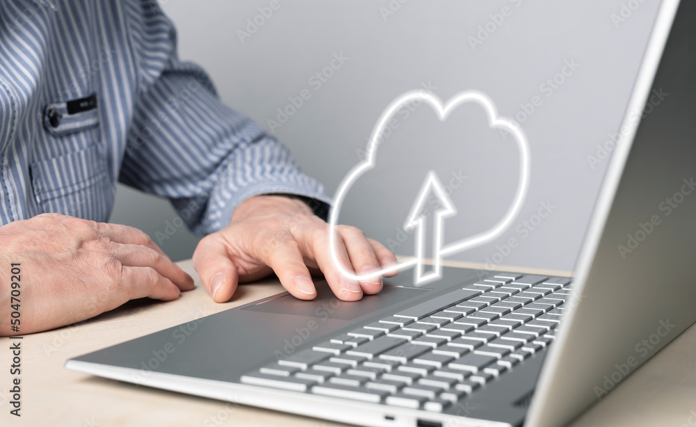 Aufkleber Cloud computing. Man using laptop for files upload, storage or sharing online. Male hand on computer touchpad closeup. High quality photo