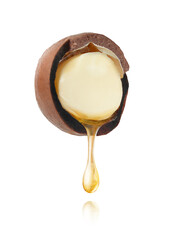 Halved macadamia nut with dripping oil on white background with clipping path.