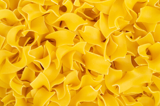 Italian quadretti or square shaped pasta background. Top view.