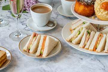Selection of gourmet cakes and mini canapes with coffee and sparkling wine on a table