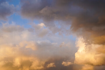 Fototapeta na wymiar Beautiful sunset sky with orange clouds lit by sun