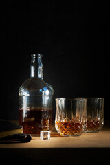 a bottle of cognac with two glasses