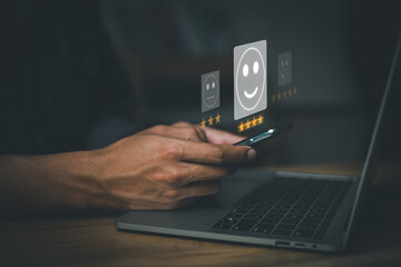 Virtual image scenario for evaluating customer satisfaction levels with mobile system. Ratings, reviews, survey responses. very happy. Man using mobile phone with laptop on wood desk in office.
